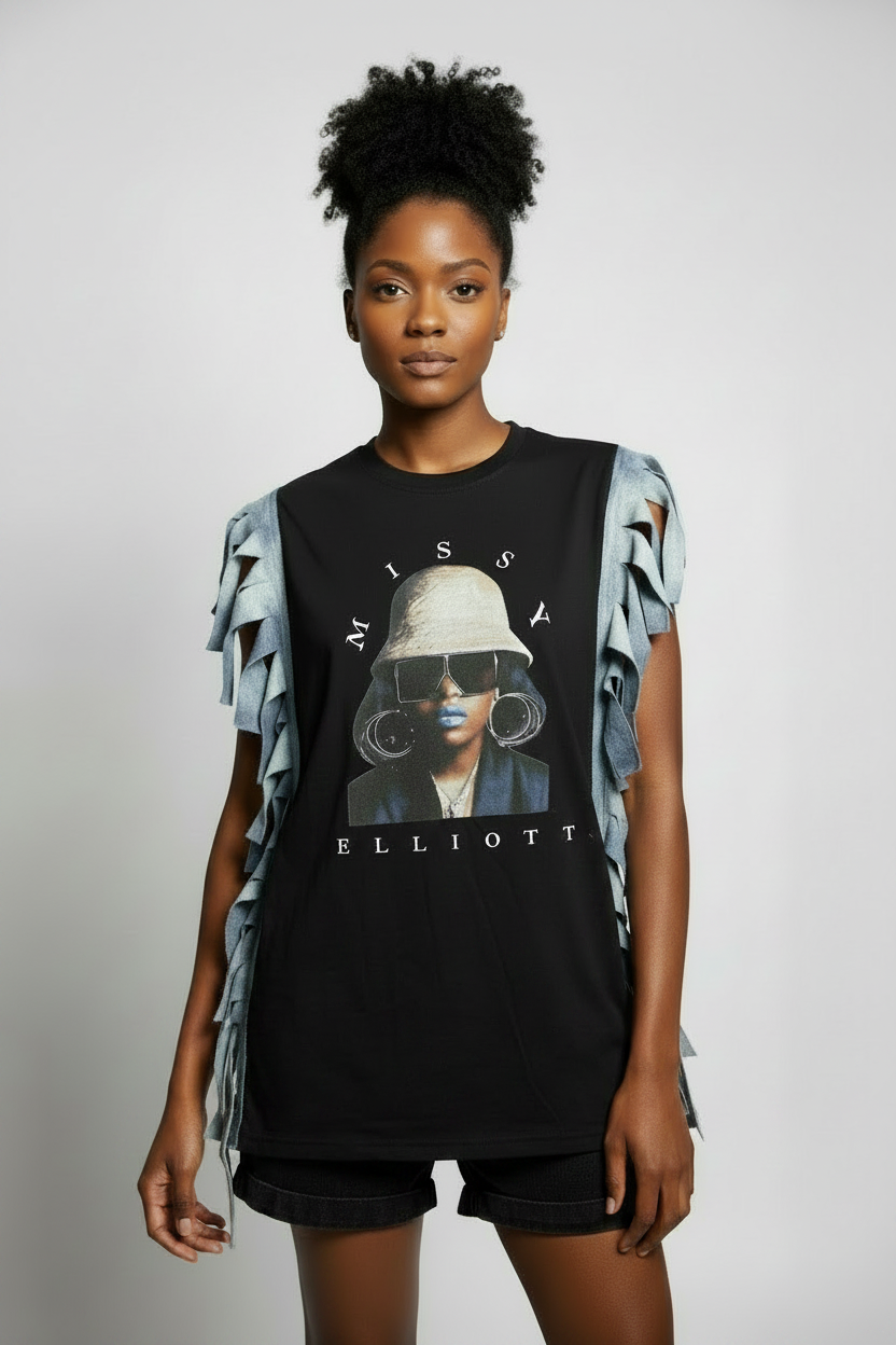 Black model with Missy Elliott fringe shirt hanging over black denim shorts